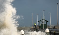 Anglers fish from a pier on Port Phillip Bay in Melbourne on Monday as wild storms batter Australia.