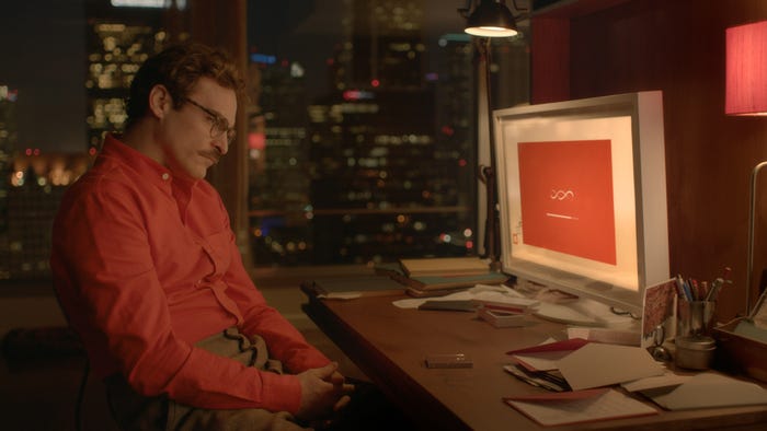 Joaquin Phoenix's character in the film "Her" sitting at a computer.