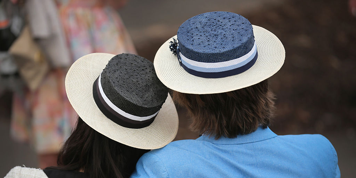 couple thinking hug hats wealthy