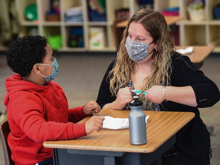 Learning Support teacher Sabrina Werley works with 4th grade student Jeremiah Ruiz at Cumru Elementary School in Cumru township Wednesday morning April 14, 2021.