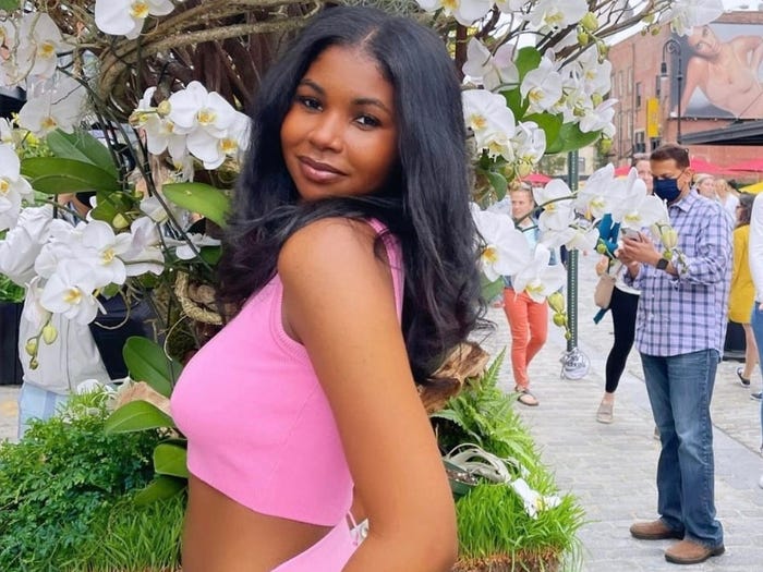 Influencer Clarke Peoples standing in front of flowers