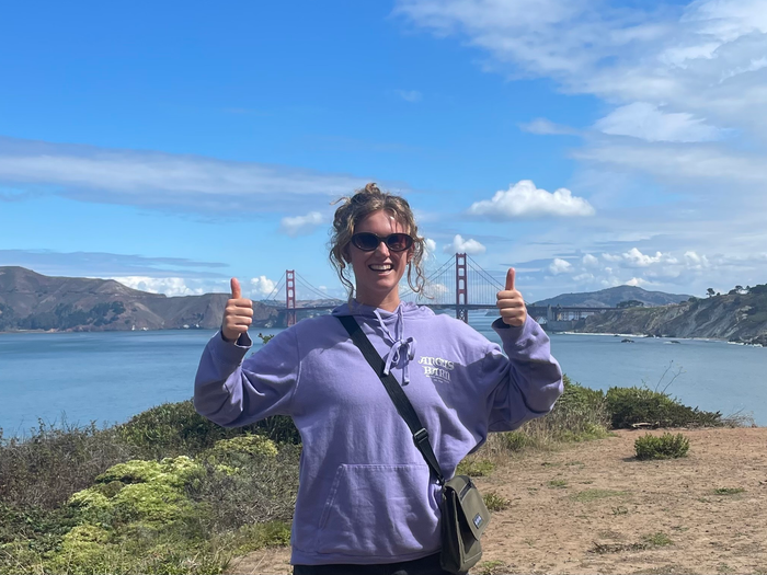 a woman gives a thumbs up in San Francisco