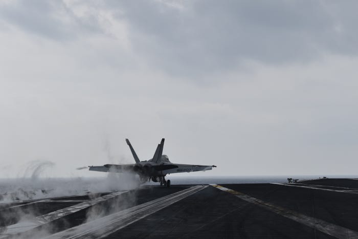 A fighter jet takes off from the deck of the USS Dwight D. Eisenhower.