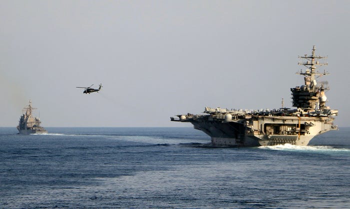 The USS Dwight D. Eisenhower and other warships cross the Strait of Hormuz into the Persian Gulf on Nov. 26, 2023 as part of a wider American deployment in the Middle East amid the Israel-Hamas war.