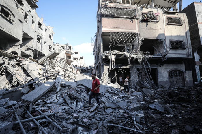 Civil defense teams and residents conduct search and rescue operations after Israeli attacks on a house belonging to the Hasnin family in the Ash-Shujaiyye neighborhood of Gaza City, Gaza, on June 27, 2024.