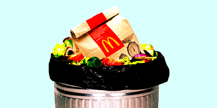 Mcdonalds' bag and a salad in a garbage can