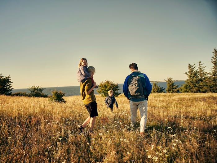 Rearview shot of a young couple out on an adventure together with their two kids