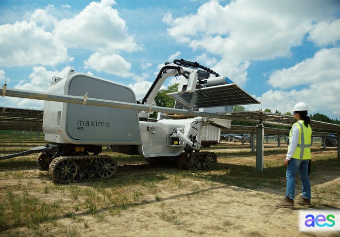 A robot on wheels lifts a solar panel.