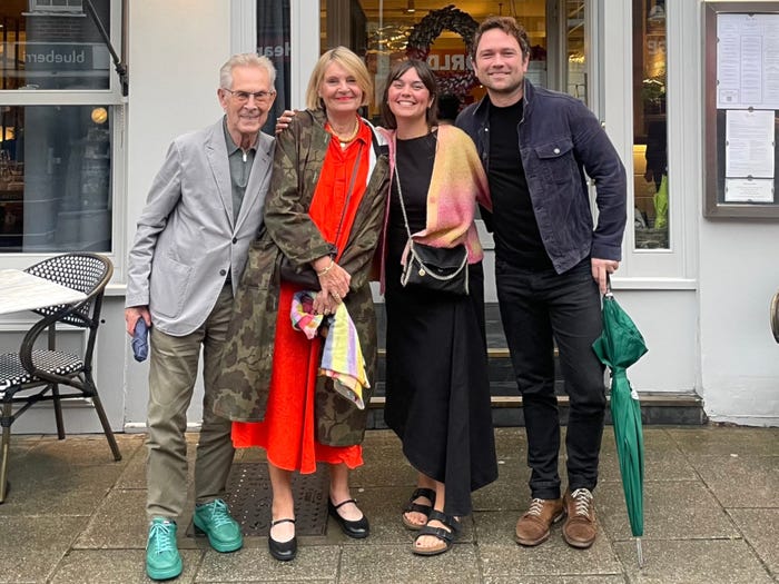 Gill and Hannah, center, on a double date with their partners Howard and Brendan, standing outside a restaurant.