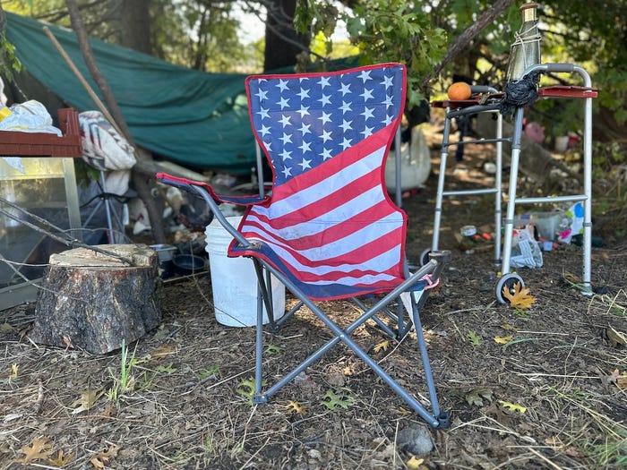 A homeless camp with an American flag chair