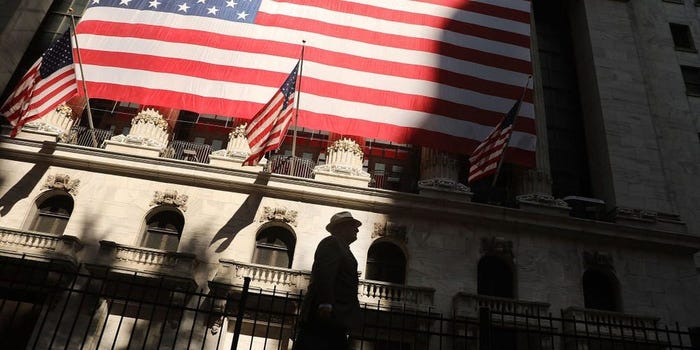 Photo of Wall Street with huge US flags