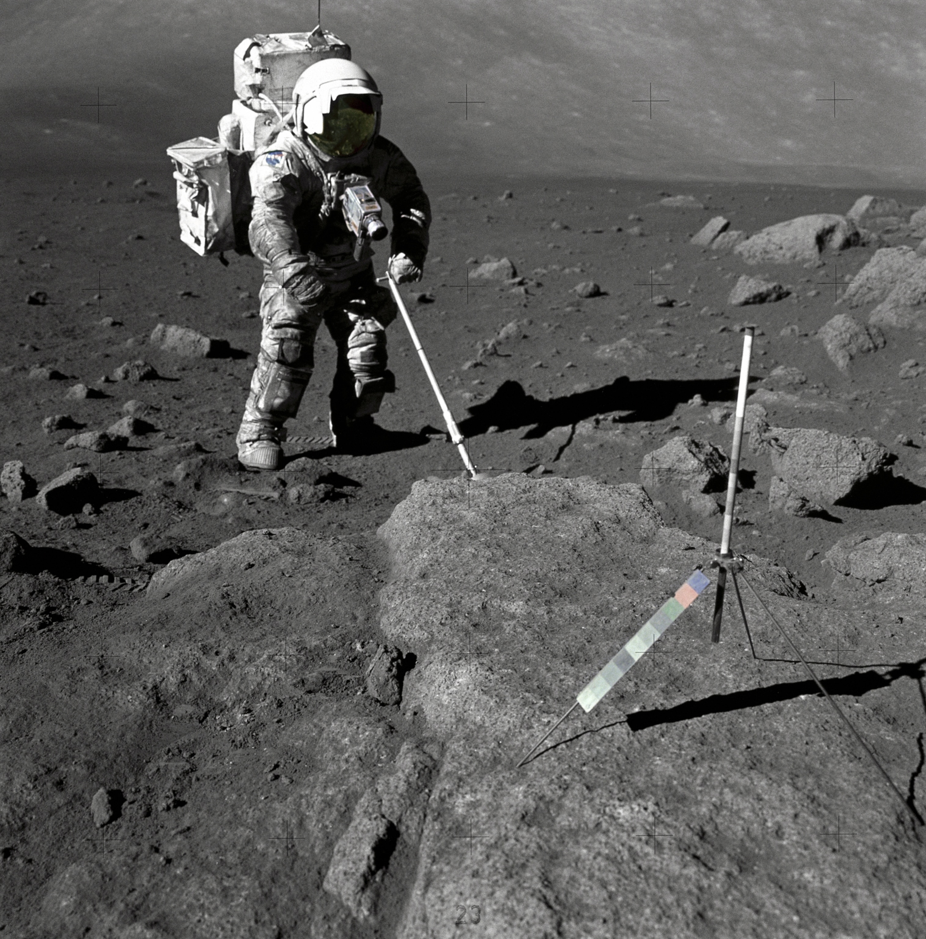 Apollo 17 astronaut Harrison Schmitt, wearing a space suit covered in moon dust as he collects samples on the moon's surface.