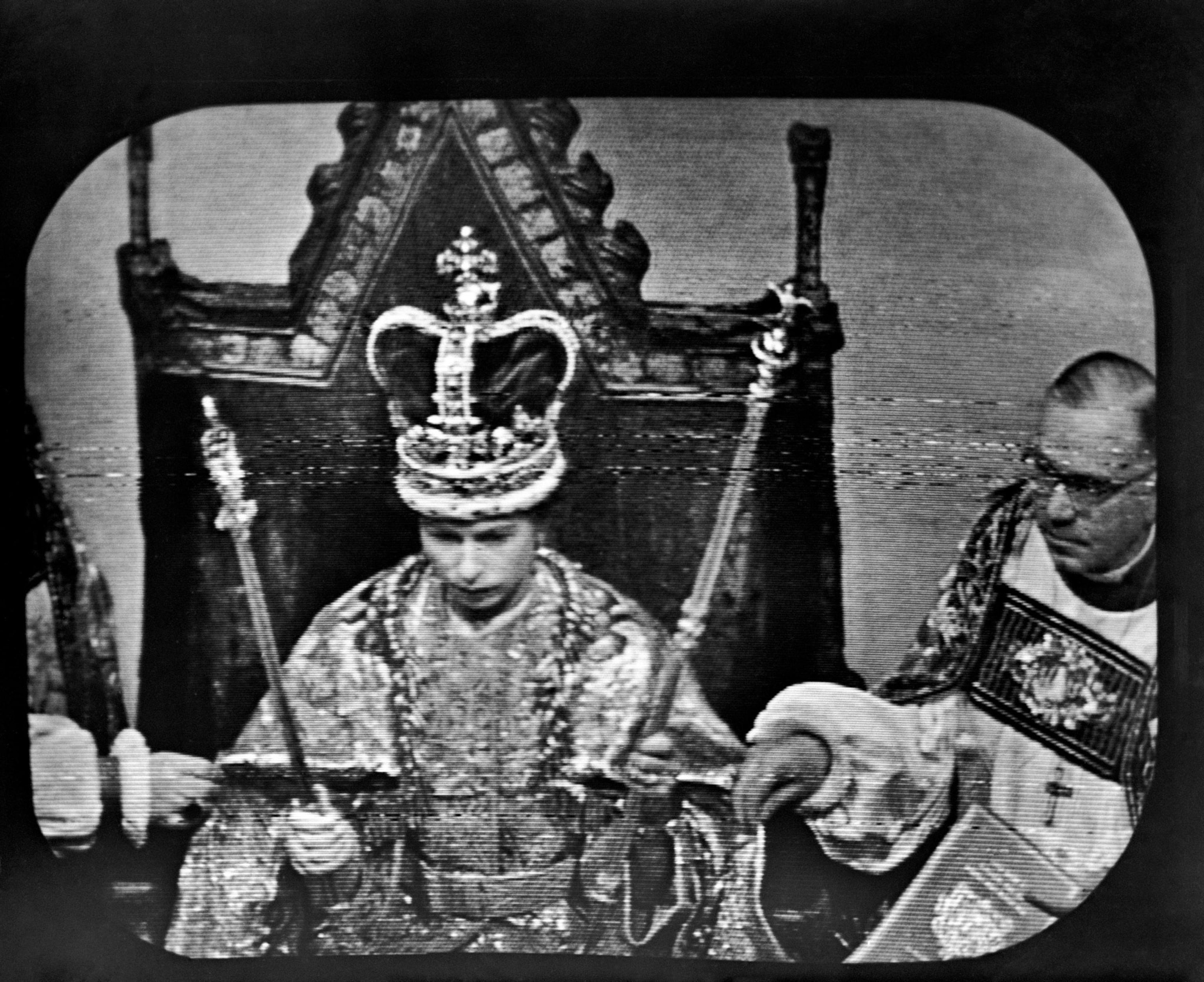 A black and white image of the queen with a crown the edges of the frame are rounded from the tv screen.