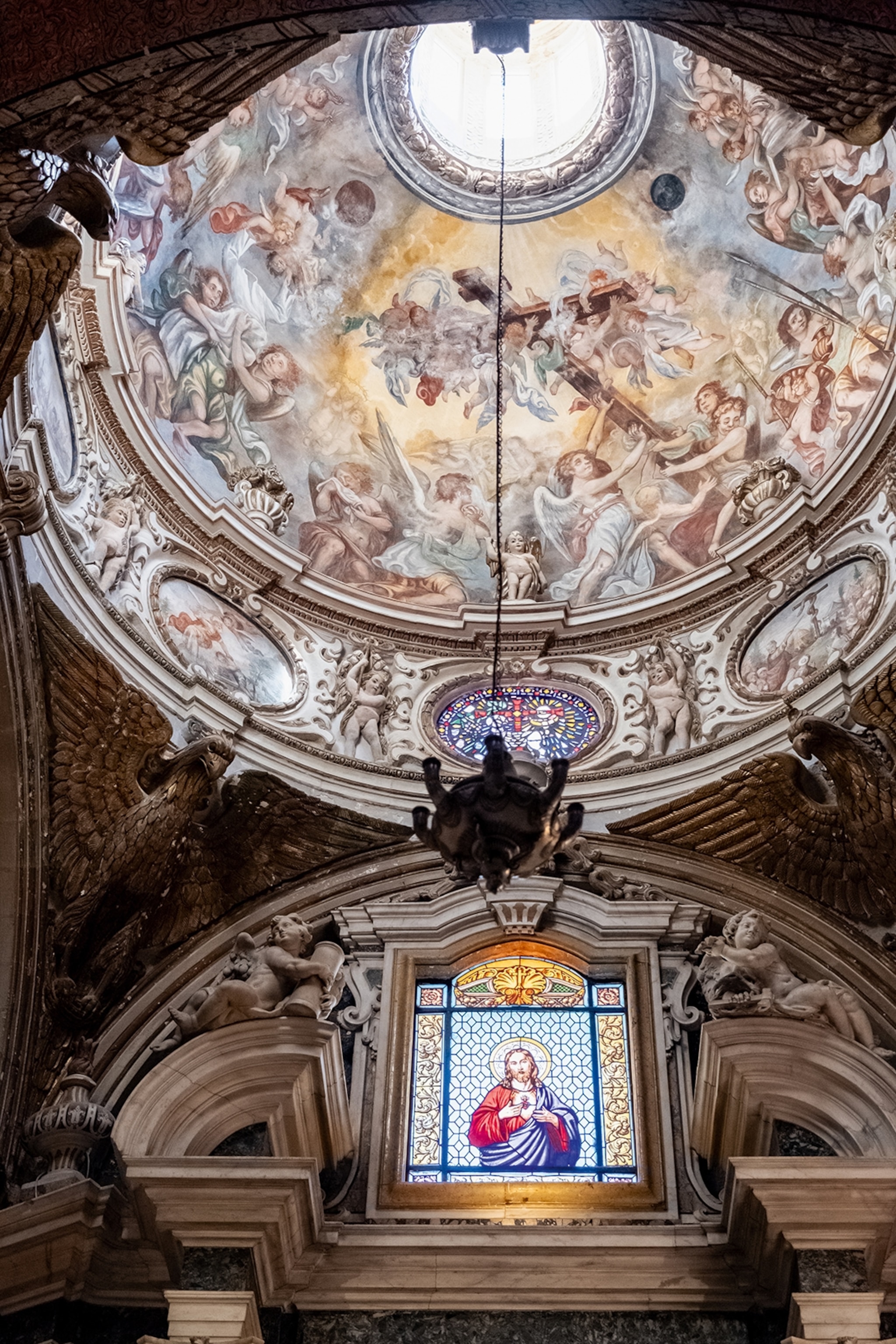 Interior of a cathedral with paintings and stained glass windows