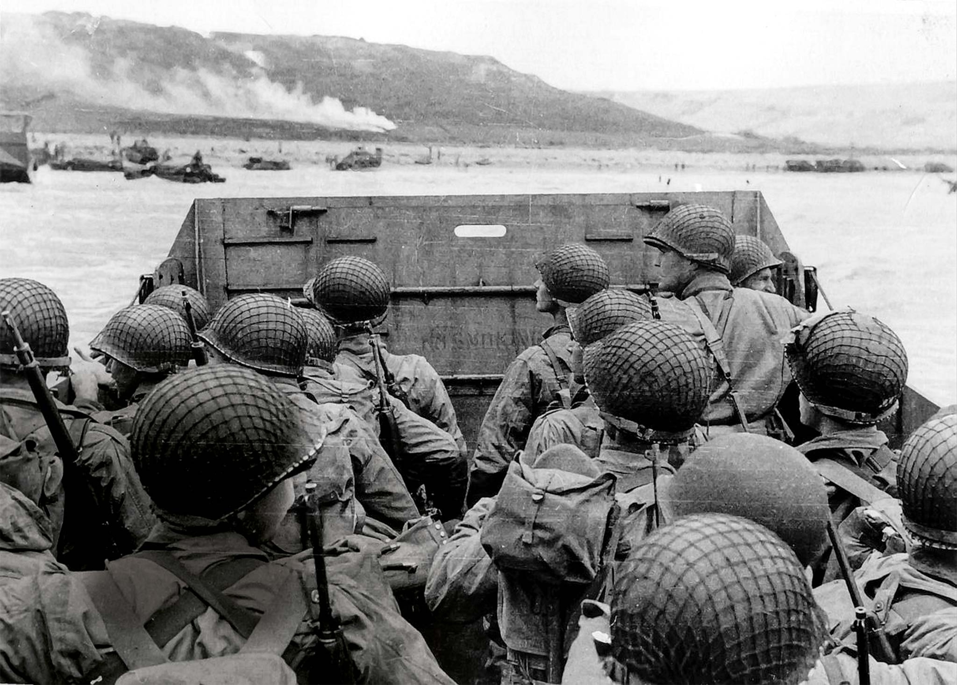 American soldiers in a landing craft approach Omaha Beach on D-Day