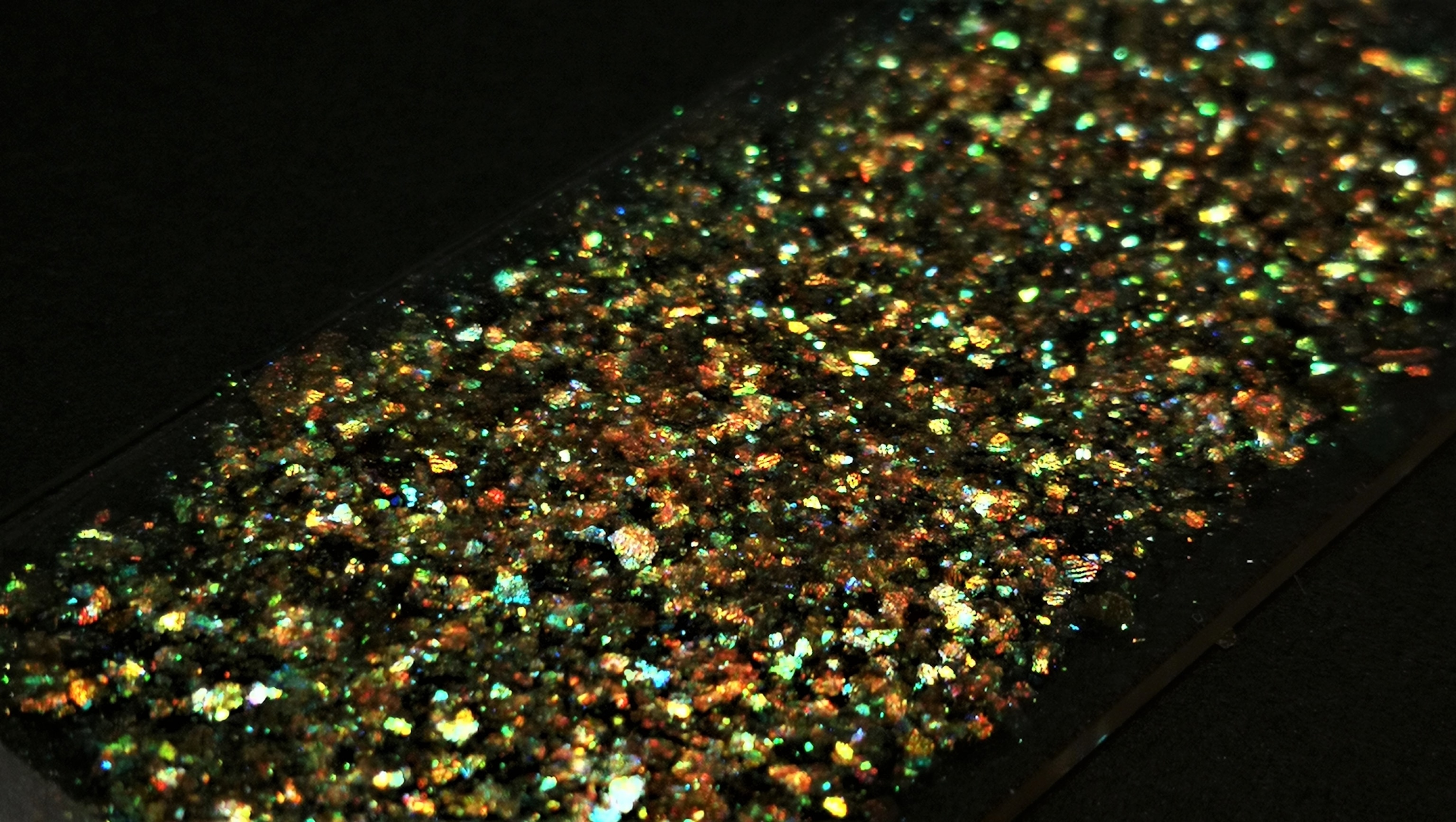 strip of gold glitter on black background