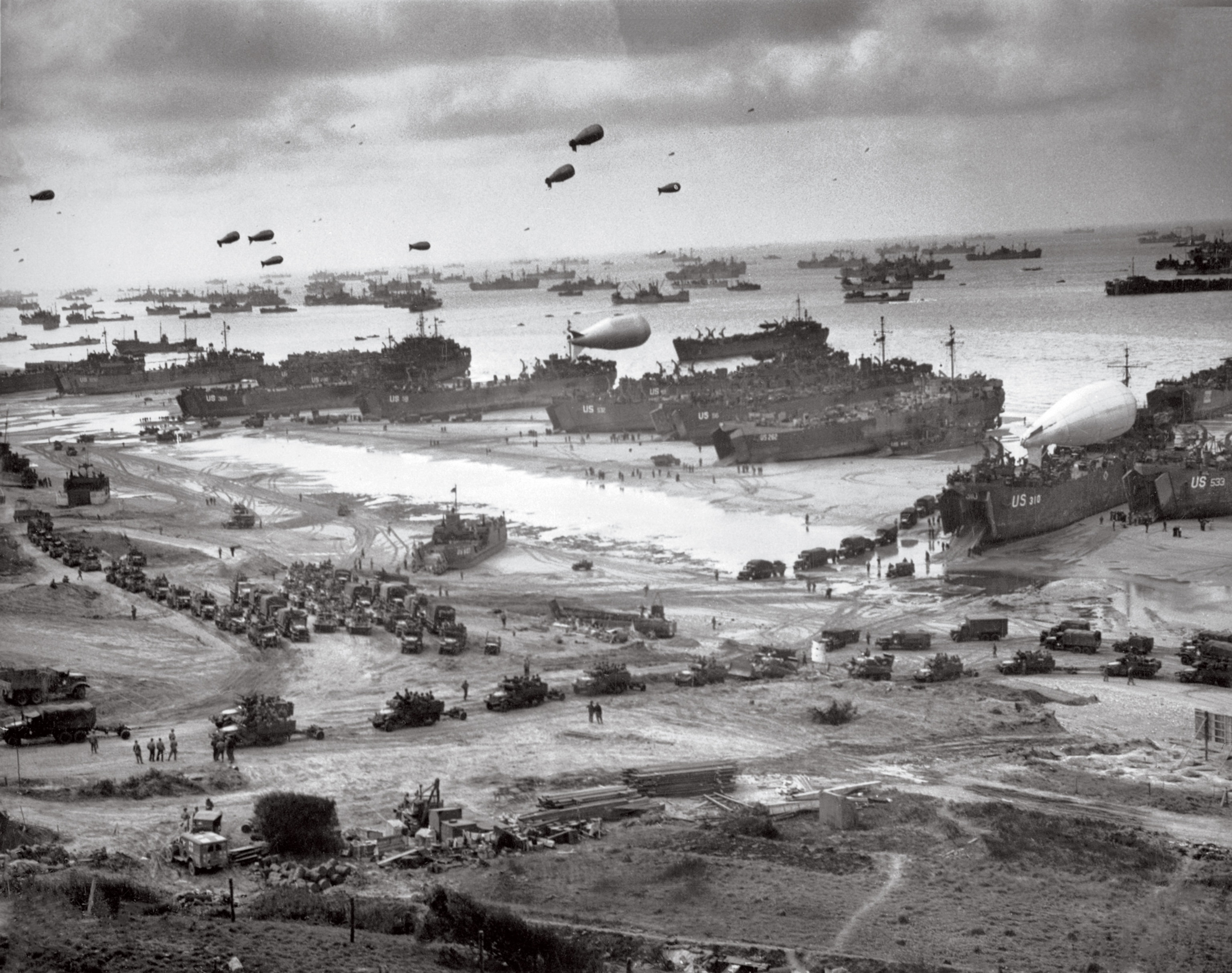 a Landing craft disgorging tanks and trucks at Omaha Beach on June 8, 1944