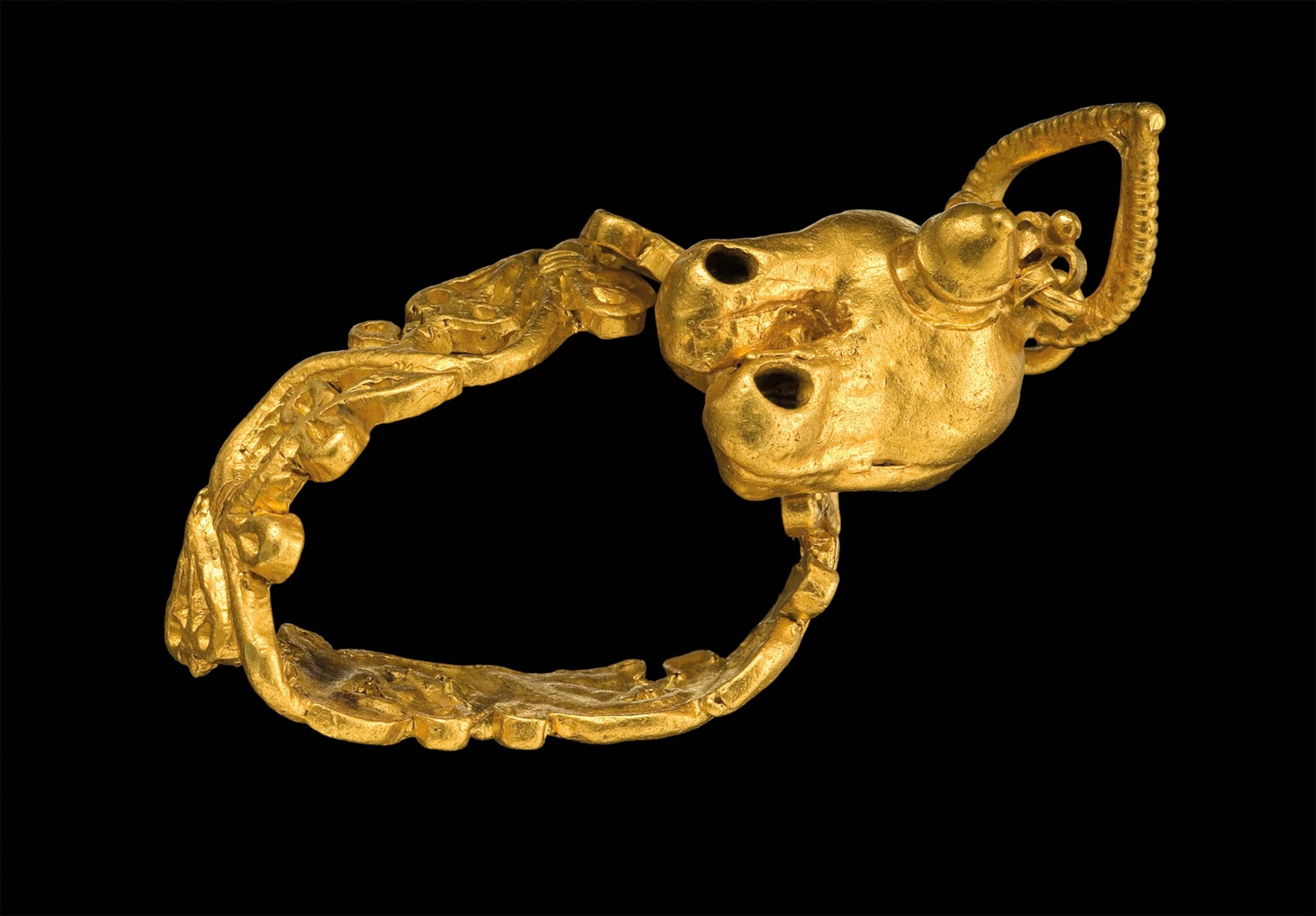 A golden ring with a miniature oil lamp