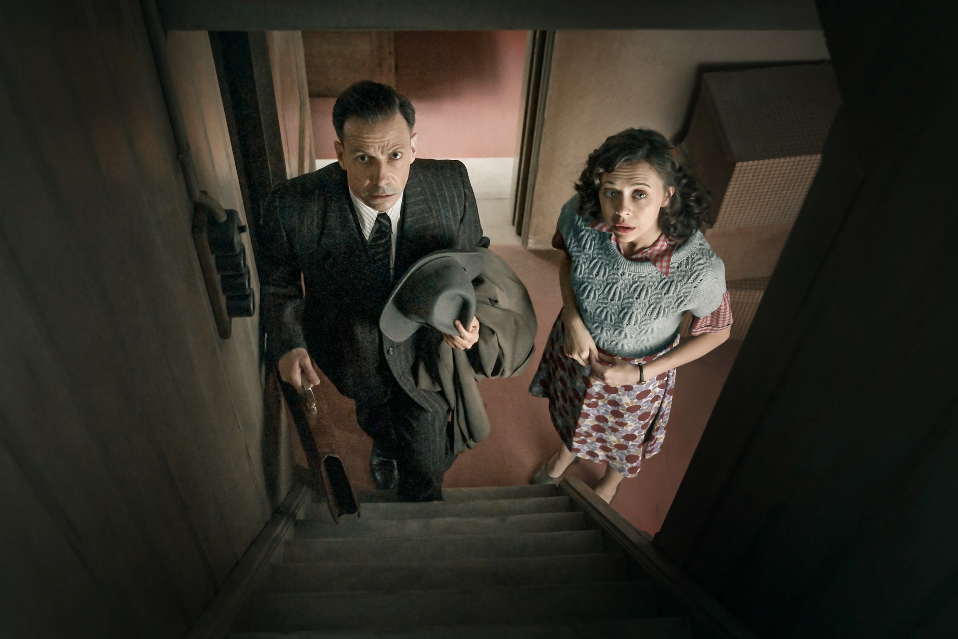 Picture of man and woman standing downstairs and looking up.