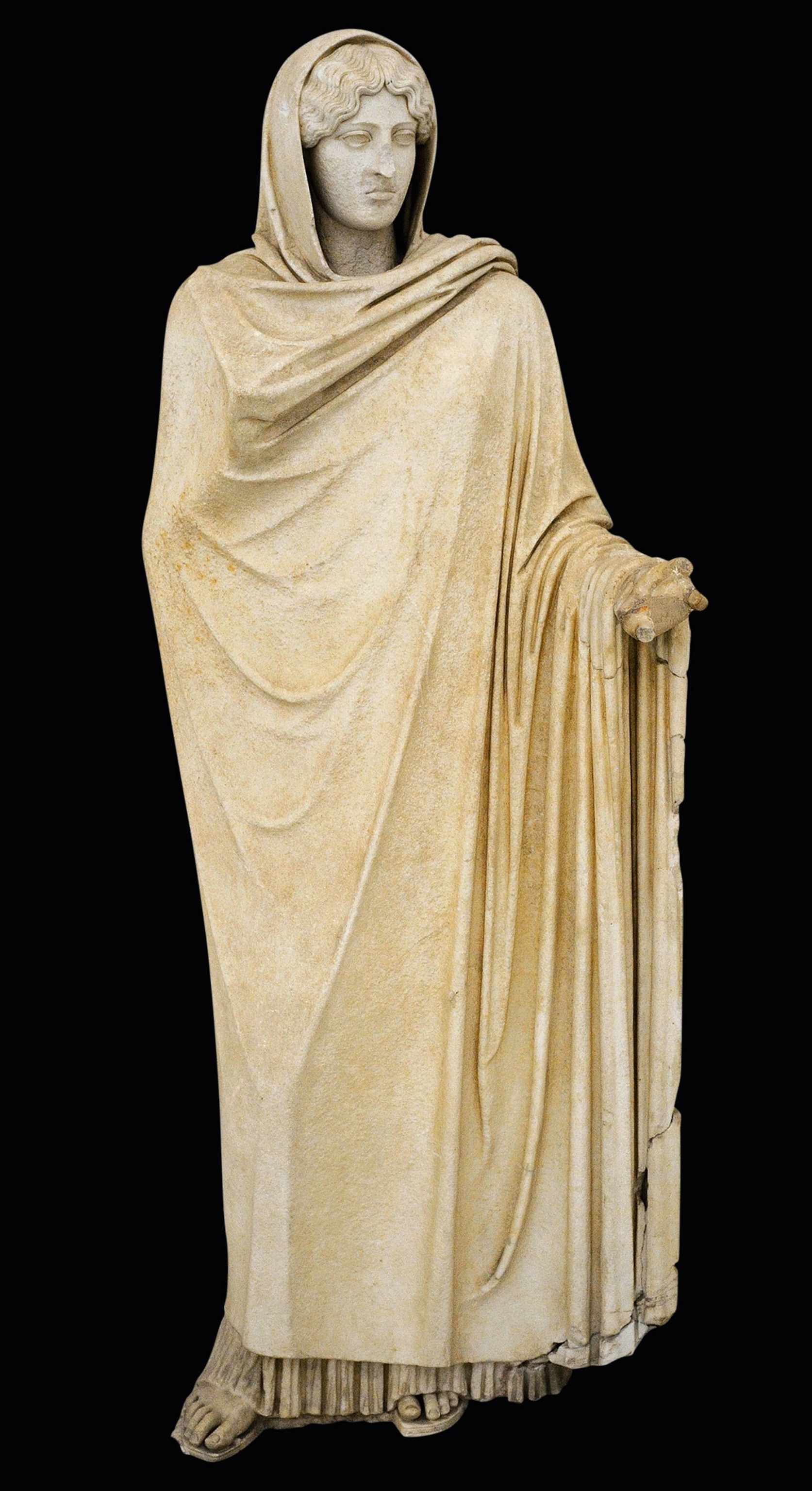 A stone statue of a woman covered in a cloak with a hood