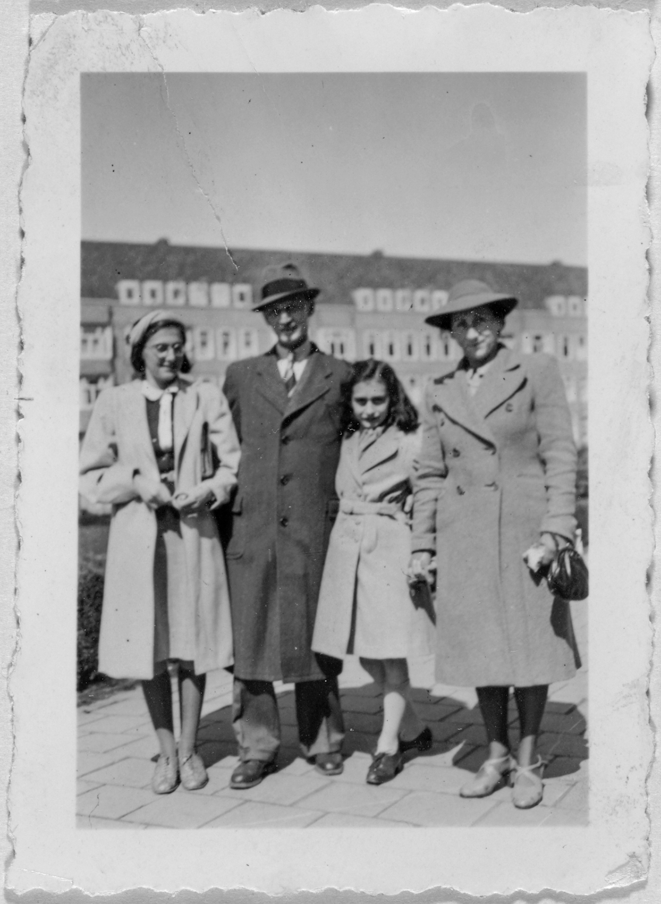 Picture of B&W photo of family posing on street.