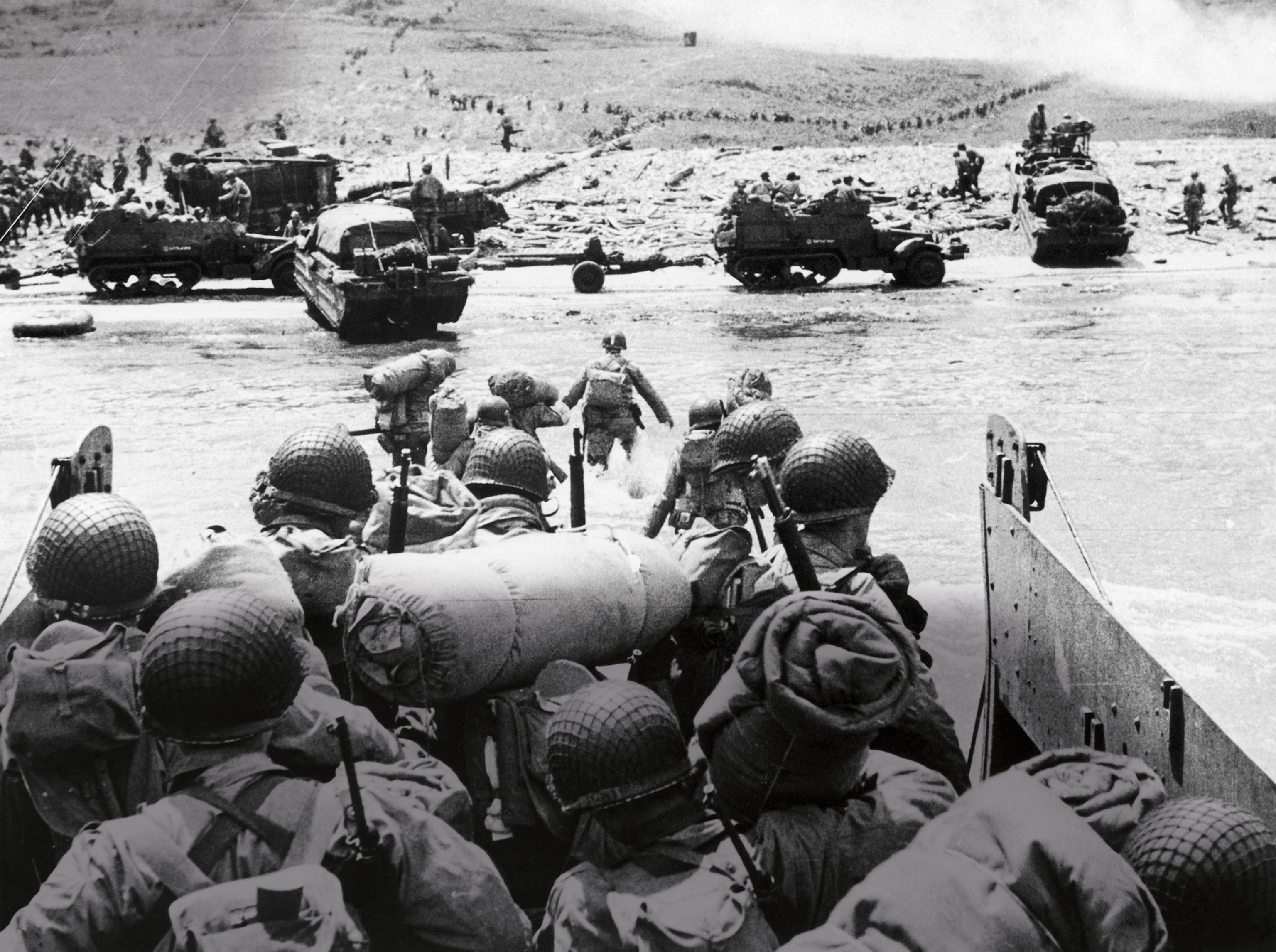 U.S. Army troops wading ashore from a landing craft to Omaha Beach, Normandy, on D-Day