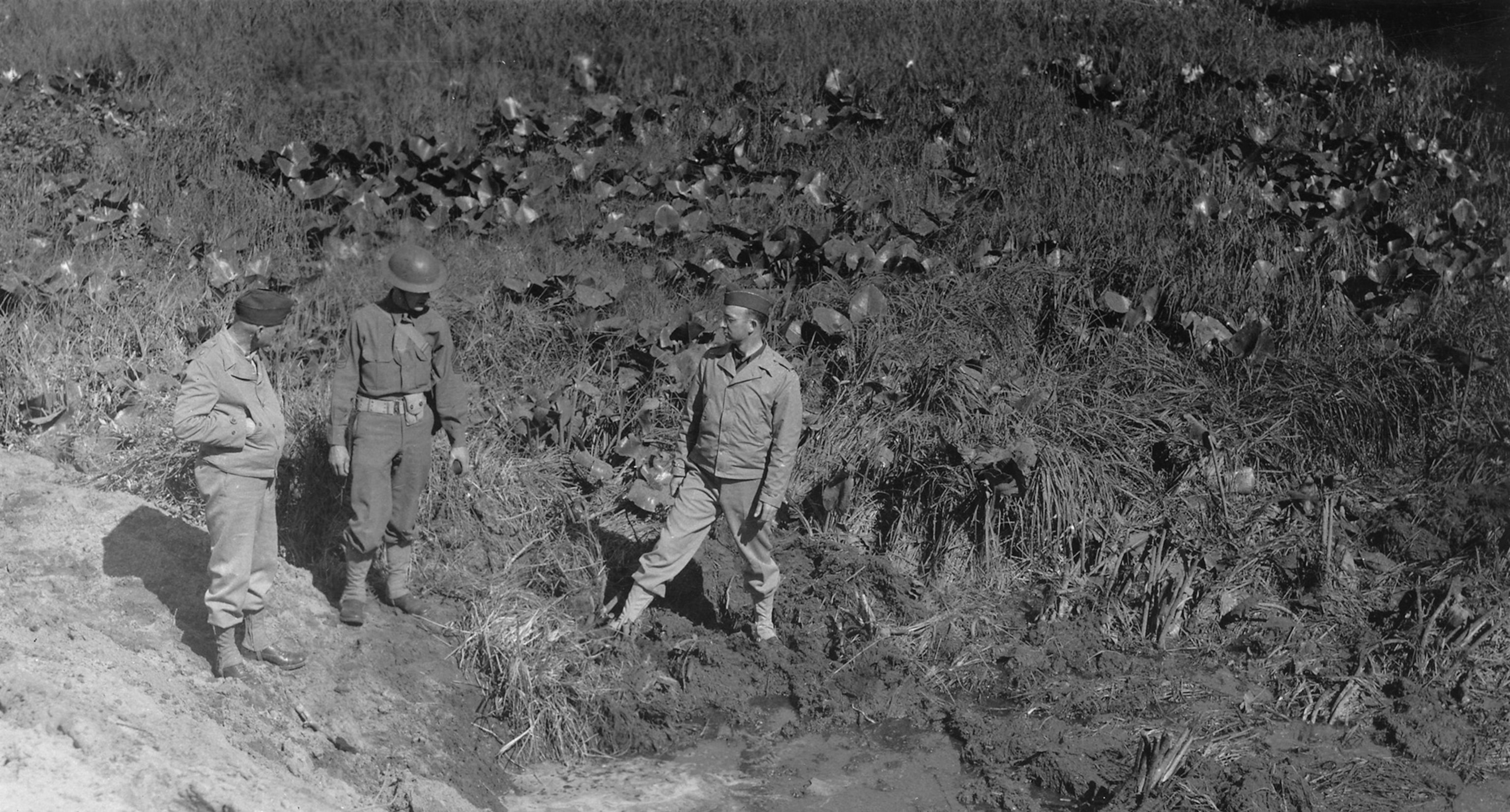 Soldiers look at damage from attack.