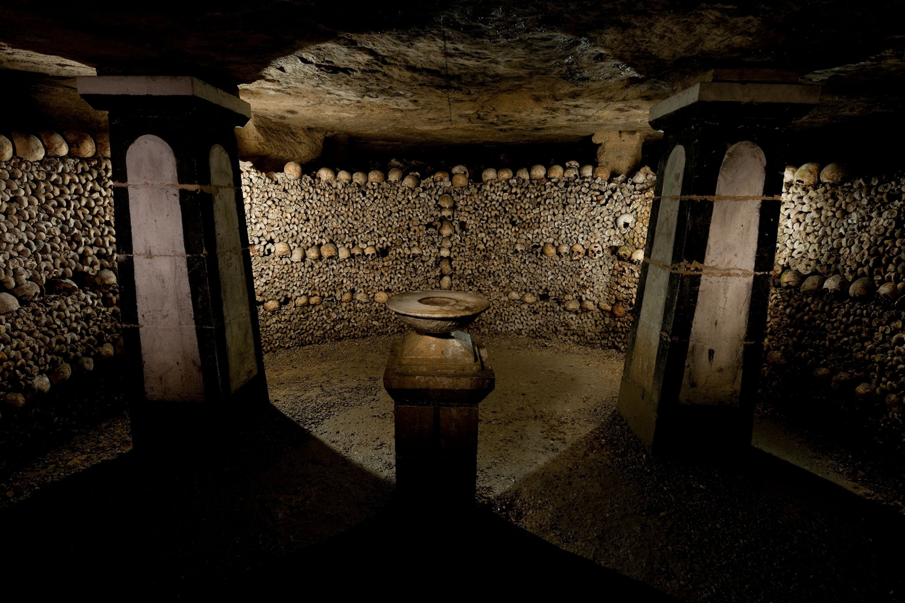 Skulls and femurs from the Cemetery of the Innocents rest in a massive ossuary.