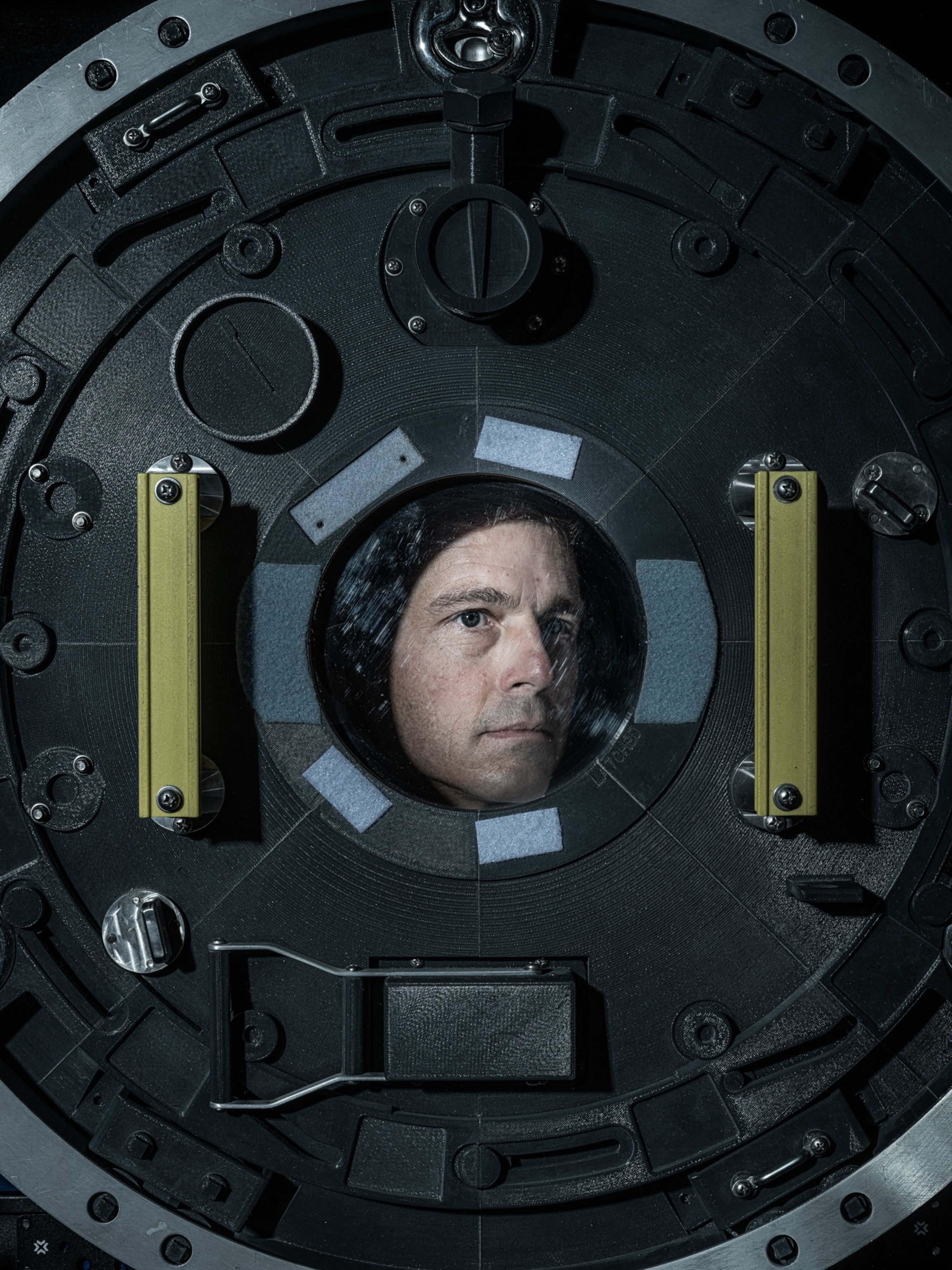 Portrait of a man taken through the small round window in chamber gate.