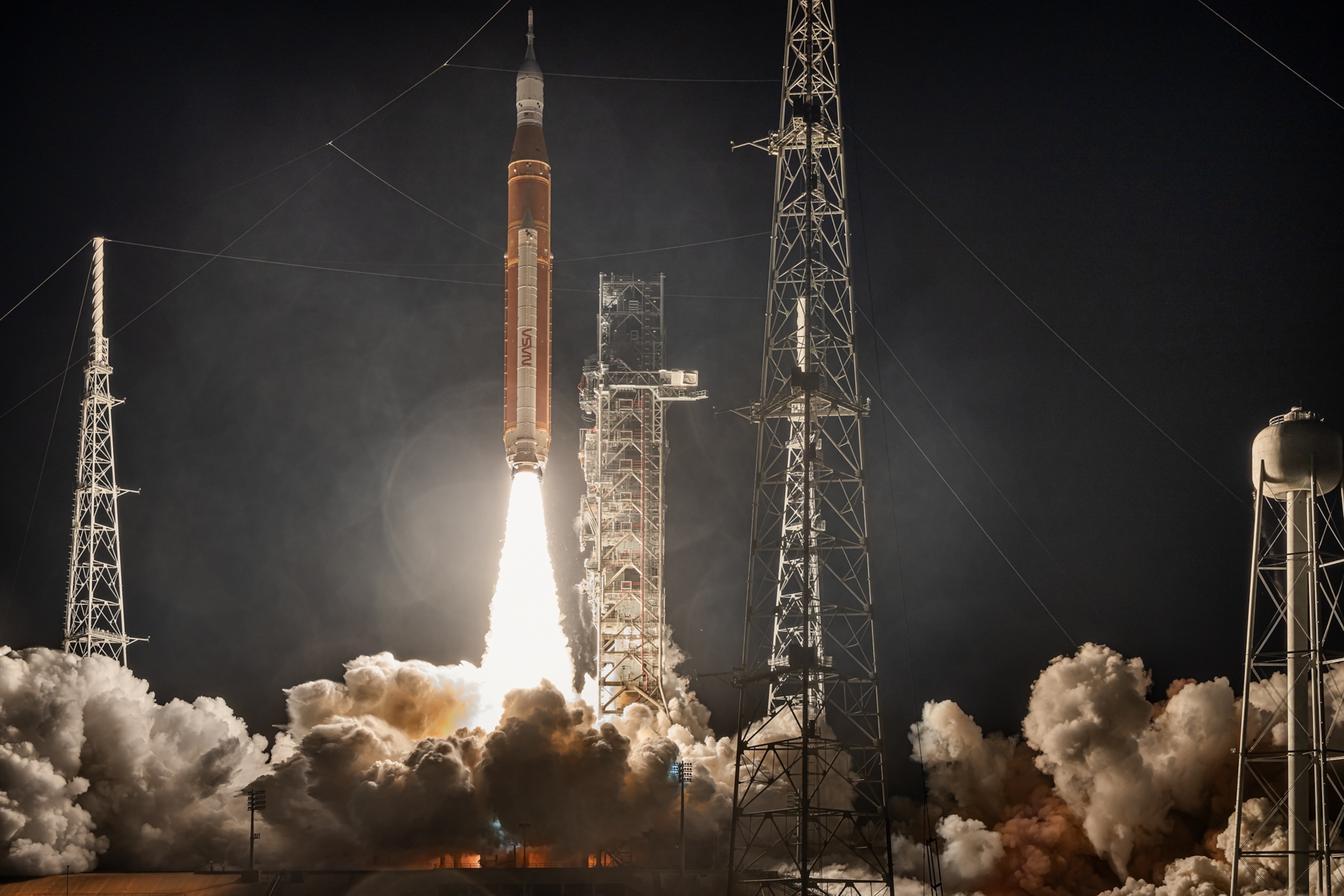 Launching moment with the rocket coming out of smoke at night.