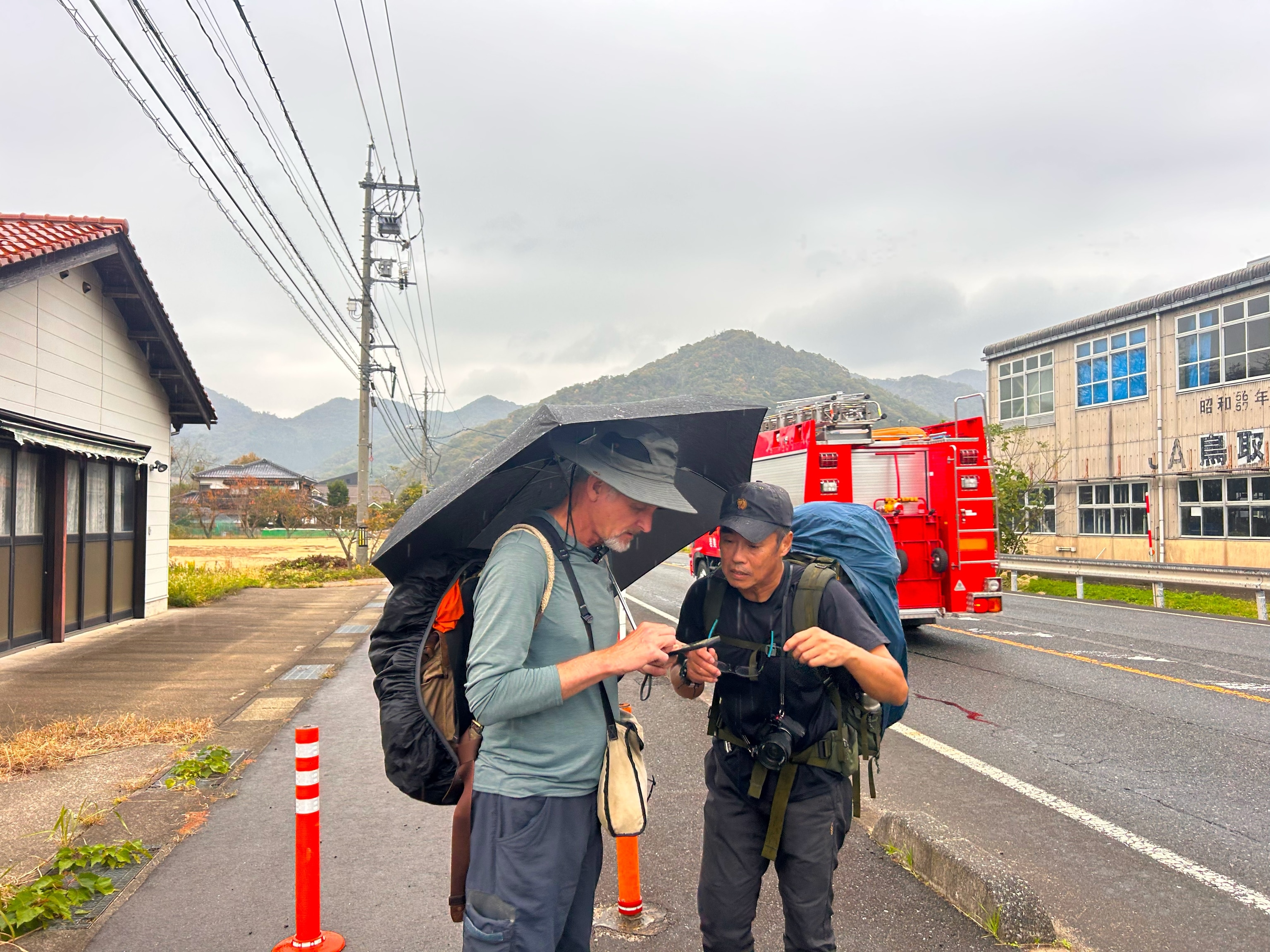 Salopek and walking partner and photographer, Soichiro Koriyama pause to route the remaining walking stretch of the day through Tottori, Japan.