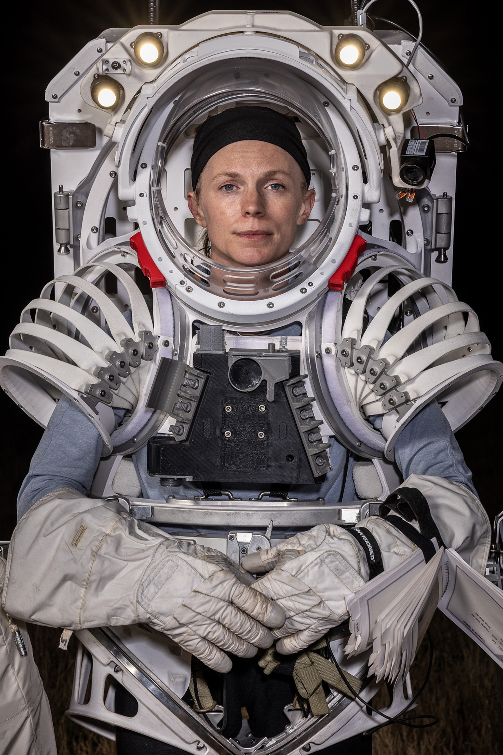 Sitting portrait of woman in space suit.