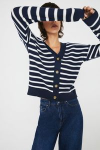 This long sleeved cardigan  in a classic breton stripe comes complete with tortoiseshell buttons. Model wears a size 8.