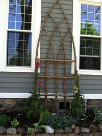 Prop this handmade trellis by local artisan K.  Hovis against the wall and plant lovely foxgloves in front.