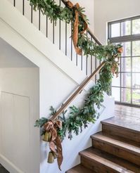 A garland is versatile and can be draped over a mantle, hung around door frames, or placed along a staircase railing. Adorn garlands with lights, ornaments, or ribbons to add layers of interest and sparkle. #winterdecor #winterdecorations #winterhomedecor #festivedecor #festivewinterdecor