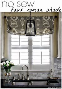 Pendant light over sink and roman shade for window