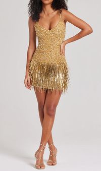 Take golden hour to the next level with our gold dress. Covered in luxurious gold beadwork this will give a high impact look. Made to accentuate your curves and flatter your figure, featuring individually hand embellished gold and silver crystal beadwork. Finished with a high shine tassel hemline, this makes an entrance to any event this season. Gentle Dry Clean OnlyColour may vary due to lighting on images. The product images (without model) are closest to the true colour of the product.Item ru