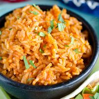 This easy Mexican rice recipe is SO simple you'll want to make it every Taco Tuesday, or as a side dish for all your Mexican meals! Click here to PIN this recipe! Taco night at home is a frequent occurrence and so Mexican rice is a side dish we often have. Back in the day...