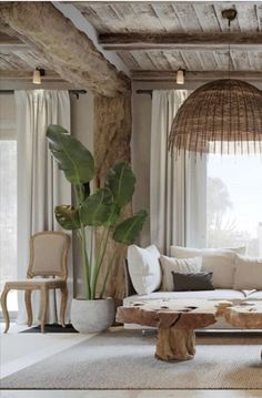 a living room filled with furniture and a large window covered in wicker coverings