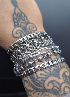 Layered Multi-Strand Steel Bracelet - This punk style or alt goth statement bracelet makes a great gift for her. All stainless steel so this bracelet will NOT tarnish. Completely water proof.  Chains may differ slightly based on stock, but will be same quality, size, and style. ⚡Sizing to help you choose the most accurate size of bracelet. ⚡ Step 1:   Measure your wrist (where you often wear your bracelets) with a tape measure or a long strip of paper, and get your wrist circumference. Step 2:   For a  snug fit, add a 1/2 inch. For a comfort fit, add 1 inch. ⭐RECOMMENDED SIZES:⭐ 7 inch: Extra small frame biological female 7.5 inch: Small frame biological female 8 inch: Medium frame biological female, small frame biological male 8.5 inch: Large frame biological female, medium frame biologic Punk Style Bracelets With Studs, Metalhead Bracelets, Adjustable Silver Punk Chain Bracelet, Adjustable Edgy Metal Chain Bracelet, Edgy Adjustable Metal Chain Bracelet, Edgy Silver Metal Chain Bracelet, Punk Stainless Steel Jewelry For Party, Punk Style Stainless Steel Jewelry For Party, Punk Style Stainless Steel Party Jewelry