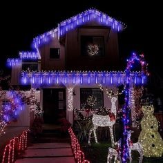 a house with christmas lights on the front and side of it, including reindeers