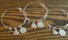 "Handmade 3pc Grandma, Mom & Daughter Family's Love Engraved Bracelet Set ~ Sterling silver plated round charm is engraved with \"A family's love is forever\" in the middle, and \"A family is a circle of love\" on the outer edge. ~ Silver plated heart charm measures 1/2 inch and are engraved with Mom, Daughter and Grandma. And a script charm that says \"Love\" ~ Made with high quality clasp rings to prevent loss of charms ~ Silver plated adjustable wire bangle bracelet fits wrists 6\" to 8\" Adjustable Charms Bracelet For Gift Making, Adjustable Charms Bracelets As Gifts, Adjustable Charms Bracelets For Gifts, Personalized Silver Charm Bracelet For Gift Making, Silver Bracelet Jewelry For Gift Making, Christmas Gifts Mom, Mom Daughter Jewelry, Grandma Bracelet, Daughter Bracelet