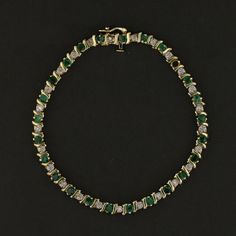 Description: This exquisite vintage 14K yellow gold bracelet features a stunning combination of vibrant green emeralds and sparkling diamonds. Weighing 9.1 grams, this elegant bracelet showcases round-cut emeralds beautifully accented by brilliant diamonds, creating a luxurious and timeless design. Perfect for special occasions or to add a touch of elegance to everyday wear, this piece is a must-have for those who appreciate vintage luxury. Specifications: Metal: 14K Yellow Gold Weight: 9.1 gram Green Diamond Bracelet For Formal Occasions, Green Emerald Bracelets For Formal Occasions, Green Emerald Bracelets For Formal Events, Formal Green Emerald Bracelets, Green Jubilee Gold Bracelet For Formal Occasions, Formal Green Gold Jubilee Bracelet, Formal Green Bracelets With Diamond Accents, Green Bracelets With Diamond Accents For Formal Occasions, Formal Green Diamond Jubilee Bracelet