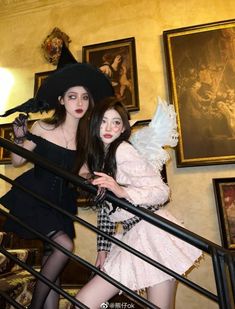 two young women dressed in costumes posing for the camera