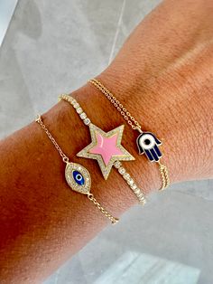 Just in time for the holidays, we've bundled some of our most-loved jewels into curated, specially priced gift sets for every taste! Our New Years prediction: the Destiny Calling Bracelet Trio is your must-have power squad of beautiful protection for 2022. Your new lineup of vibe guardians includes the glam-and-glowing Pink Star Crystal Bracelet, the delicate and dazzling Third Eye Open Bracelet, and the pint-sized powerhouse Onyx Hamsa Bracelet. Arm yourself with these gorgeous gems and see wha Third Eye Open, Bracelet Trio, Bracelet Arm, Third Eye Opening, Open Bracelet, Star Crystal, Hamsa Bracelet, Pink Stars, Gift Sets