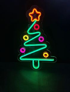 a neon christmas tree with stars on it