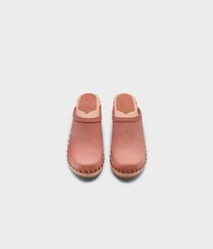 Made by skilled artisans in Sweden, these blush pink nubuck clog mules feature a high heel and eye-catching stud detailing on the sides. From date nights to ladies' nights out, Rome delivers unparalleled style and confidence. Clog measurements:Heel height: 2 5/8” (6.5 cm)Toe height:﻿ 1 1/2″ (3.8 cm) Fit:NarrowLeather:Nubuck leatherClogs consist of:Base: European Lime Wood Sole: Rubber sole Fastening: Brass studs Pink Mules With Wooden Heel For Spring, Pink Spring Mules With Rubber Sole, Spring Pink Mules With Rubber Sole, Spring Pink Mules With Wooden Heel, Pink Leather Slip-on Mules, Pink Rubber Sole Clogs For Spring, Pink Mules With Wooden Heel And Round Toe, Pink Spring Clogs With Rubber Sole, Spring High Heel Clogs With Studded Rubber Outsoles