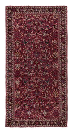 a red rug with an intricate design on the bottom and sides, in various colors