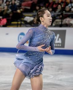 a female figure skating on an ice rink