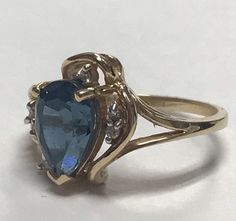 STUNNING 14K Yellow Gold Pear Shape BLUE TOPAZ and DIAMONDS Ring Size 6 It is a size 6 Total weight of 3.7 grams solid 14K gold! Large pear 6mm x 9mm Blue Topaz set into a 14k Yellow Gold setting with (7) seven small round genuine diamonds. It is a beautiful ring and it will look beautiful on any one who wears it! Ships in gift box and insured!